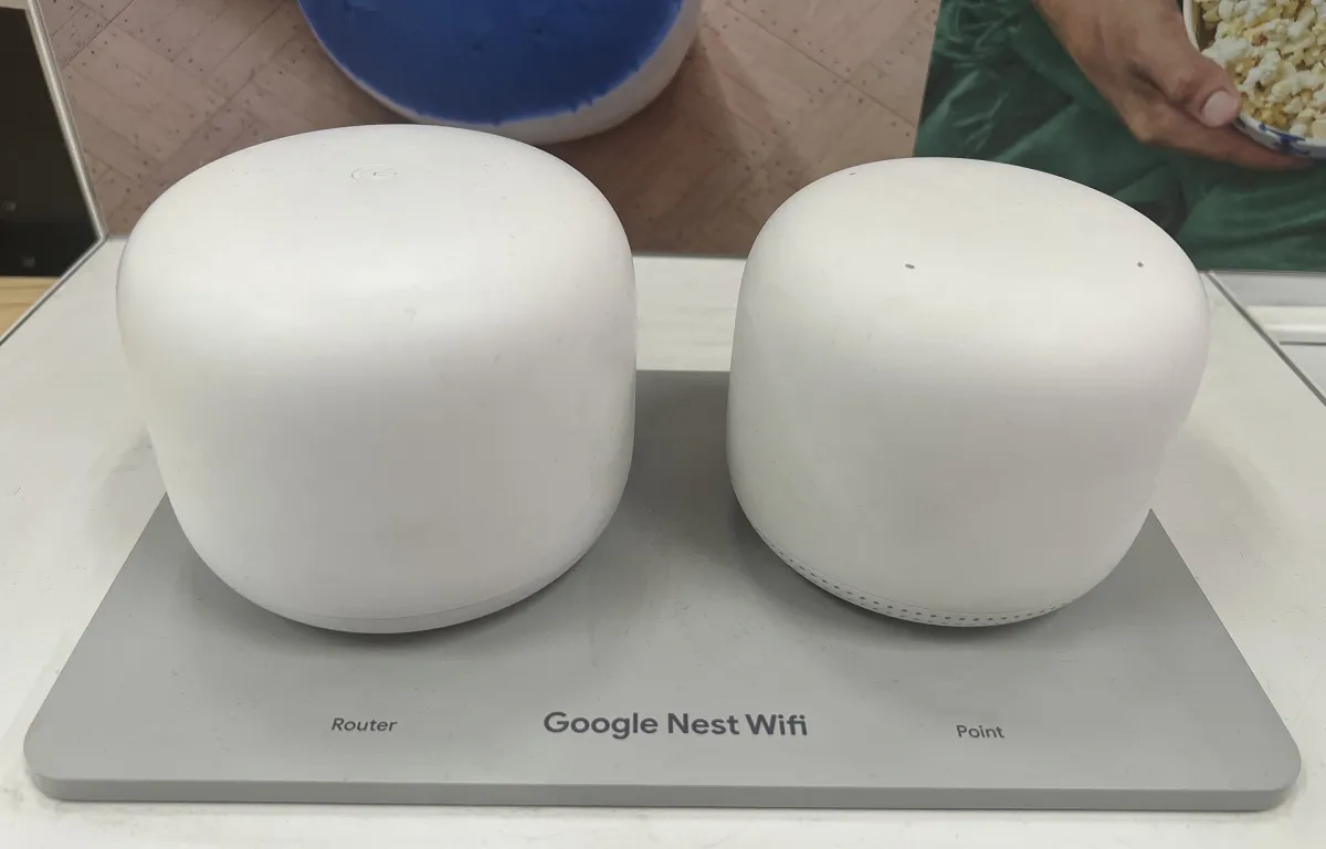 White Google Nest Wifi router and point side by side on a labelled retail display.