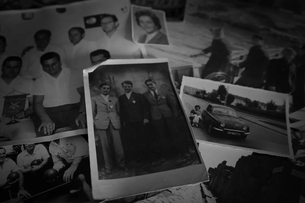 Overlapping black-and-white printed photographs of people, with a portrait of three men in the foreground.