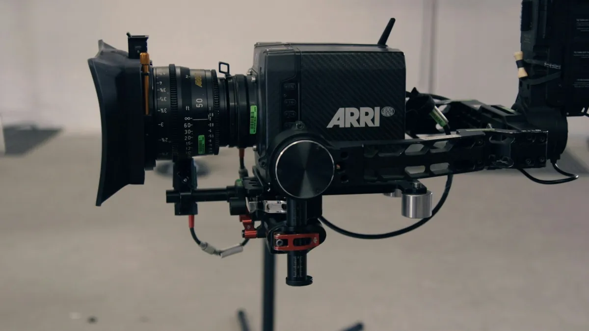 ARRI cinema camera with a large lens mounted in a handheld camera rig.